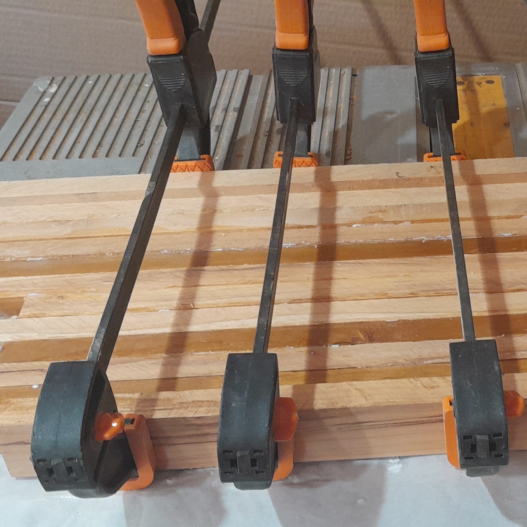 Lengths of timber glued and clamped together during construction in the KJ Creations NZ workshop.